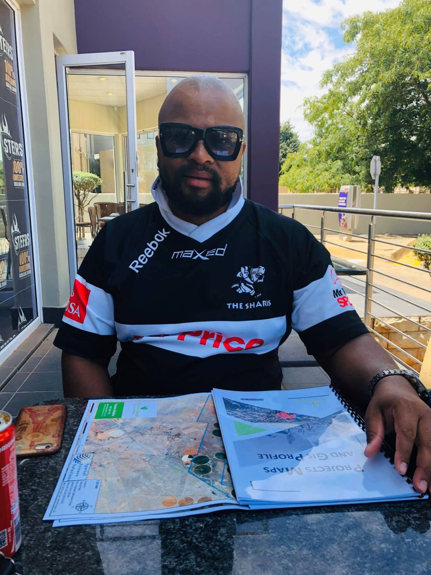 Teboho Modise reviewing project maps and a GIS profile report